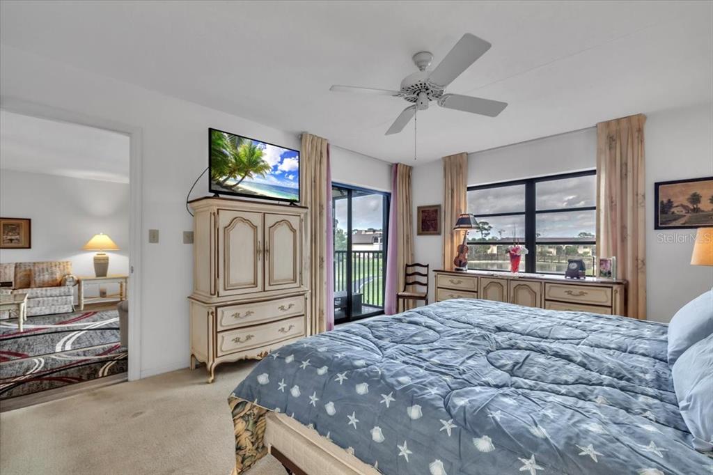 23465 Harbor View Road, Unit 723 Port Charlotte, FL 33980 - Photo 16 of 42 a bed room with a bed and a television