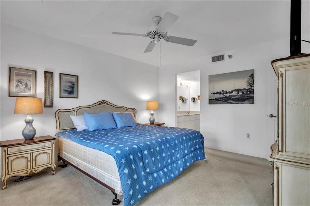 23465 Harbor View Road, Unit 723 Port Charlotte, FL 33980 - Photo 17 of 42 a bedroom with a bed and a chandelier