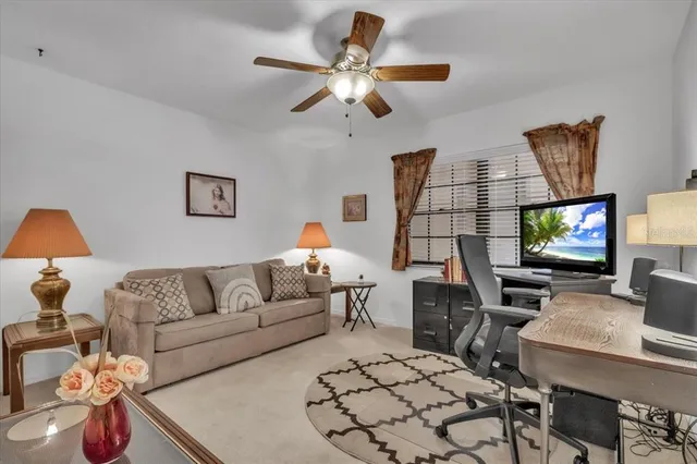 a living room with furniture a chandelier and a window