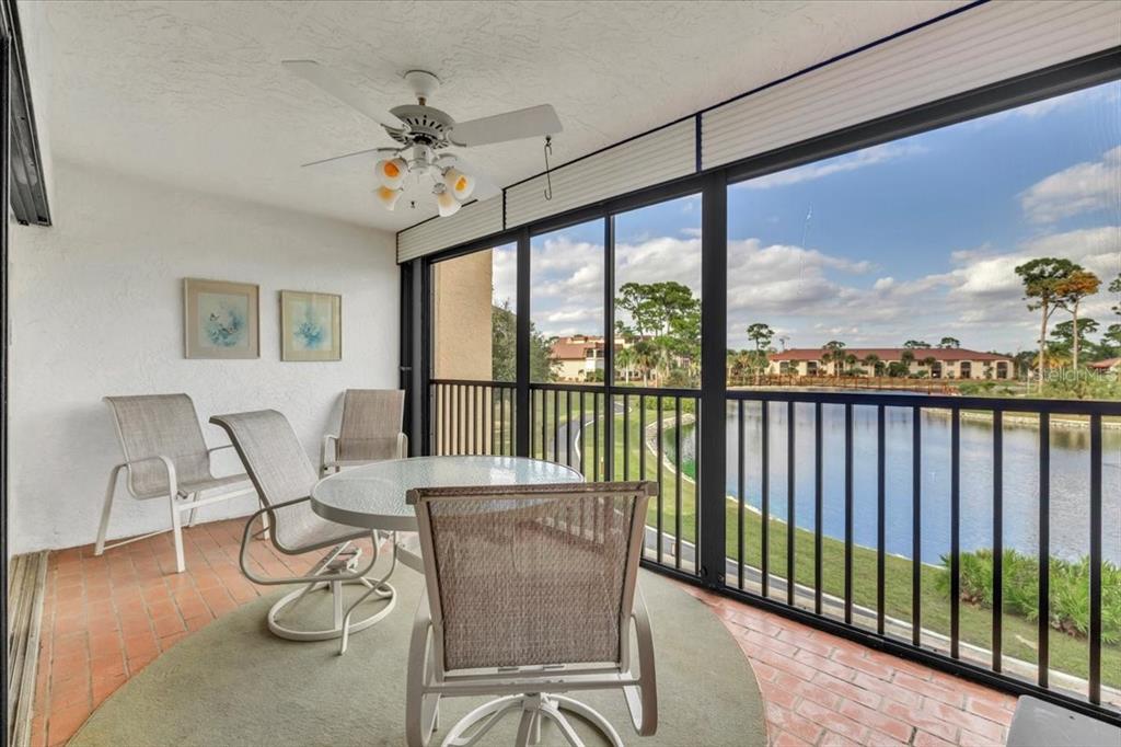 23465 Harbor View Road, Unit 723 Port Charlotte, FL 33980 - Photo 3 of 42 a living room with furniture and a floor to ceiling window