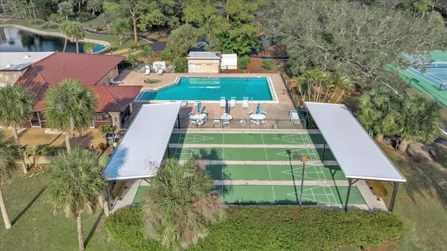an aerial view of a house with outdoor space and lake view