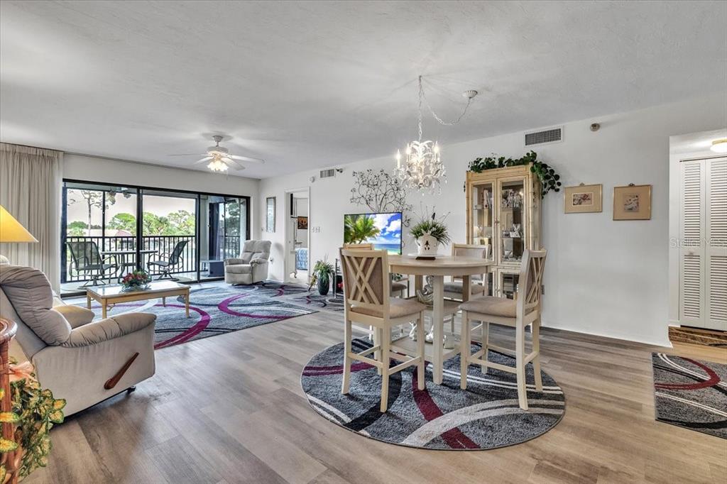 23465 Harbor View Road, Unit 723 Port Charlotte, FL 33980 - Photo 5 of 42 a living room with furniture and wooden floor