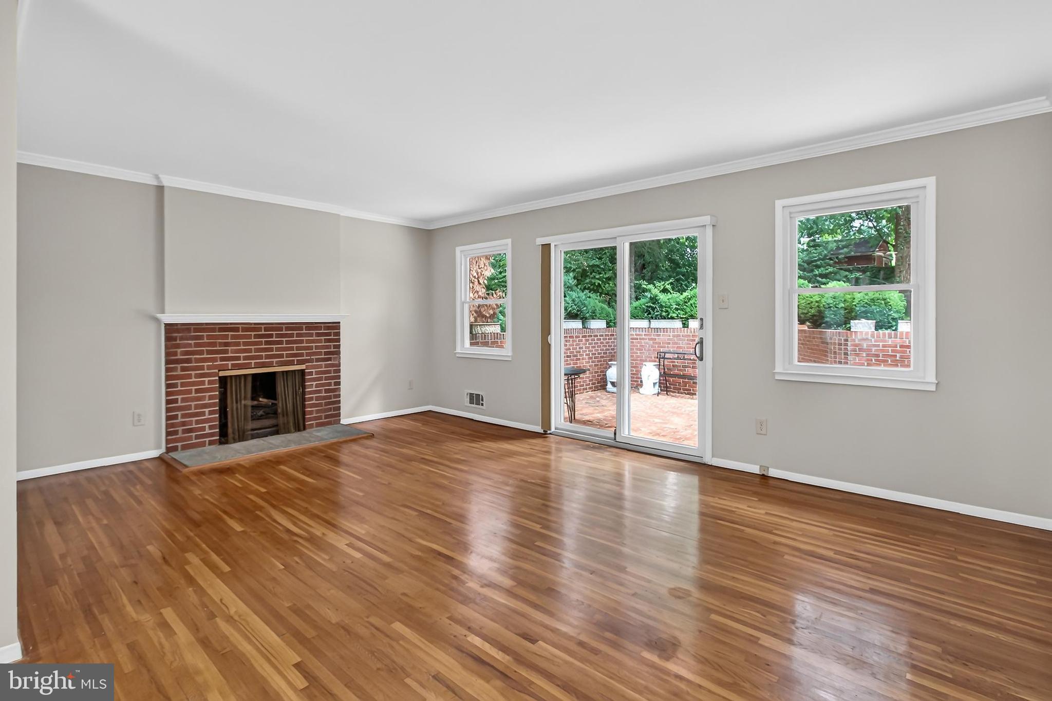 7604 Boulder Street Springfield, VA 22151 - Photo 3 of 39 a view of an empty room with wooden floor and a window