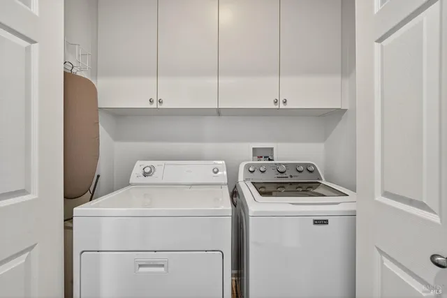 a view of storage and utility room with washer and dryer