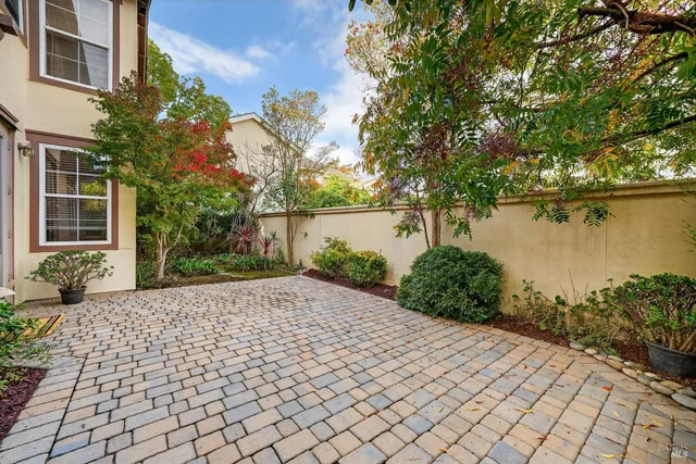 a pathway of a house with a yard