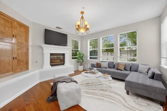 a living room with furniture fireplace and flat screen tv