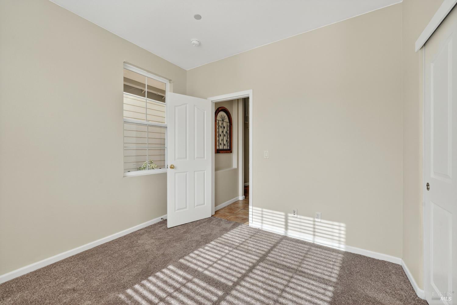 23 Greenham Court Novato, CA 94949 - Photo 8 of 20 a view of an empty room with wooden floor and a window