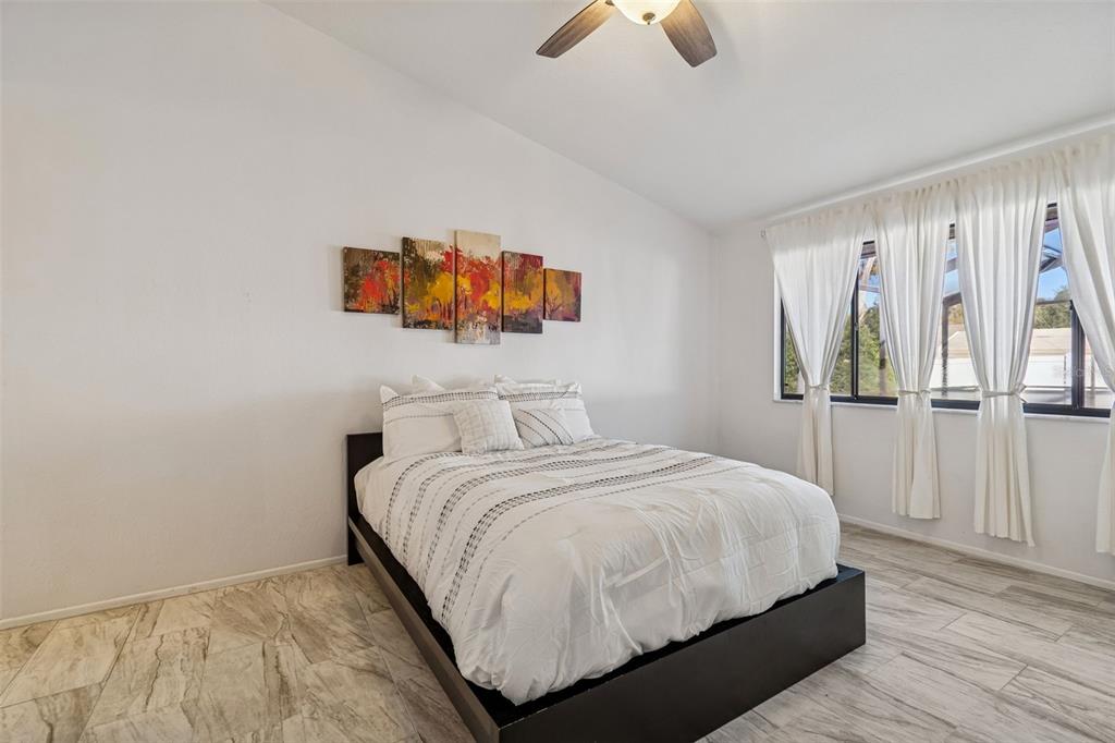 14301 86th Avenue North Seminole, FL 33776 - Photo 14 of 59 a bedroom with a bed and painting on the wall