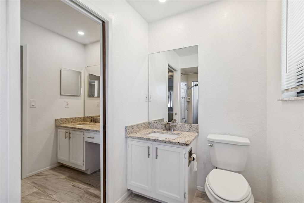 14301 86th Avenue North Seminole, FL 33776 - Photo 22 of 59 a bathroom with a toilet sink and mirror