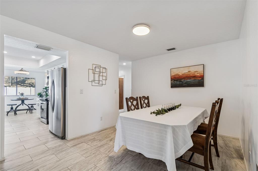 14301 86th Avenue North Seminole, FL 33776 - Photo 25 of 59 a view of a dining room with furniture and a livingroom