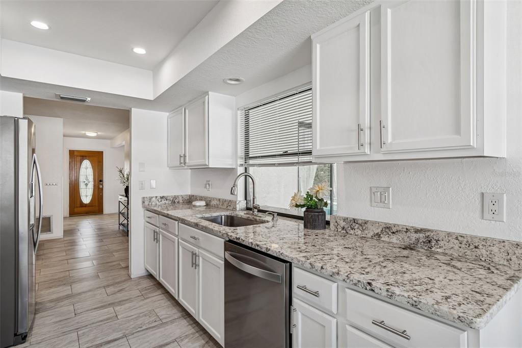14301 86th Avenue North Seminole, FL 33776 - Photo 29 of 59 a kitchen with stainless steel appliances granite countertop a sink stove and cabinets