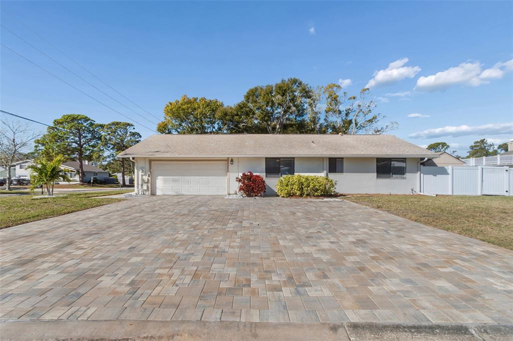 14301 86th Avenue North Seminole, FL 33776 - Photo 3 of 59 a front view of a house with a yard and a garage