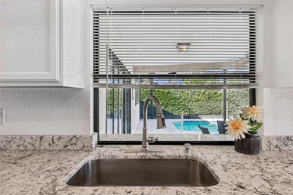 14301 86th Avenue North Seminole, FL 33776 - Photo 31 of 59 a kitchen with a sink and a window