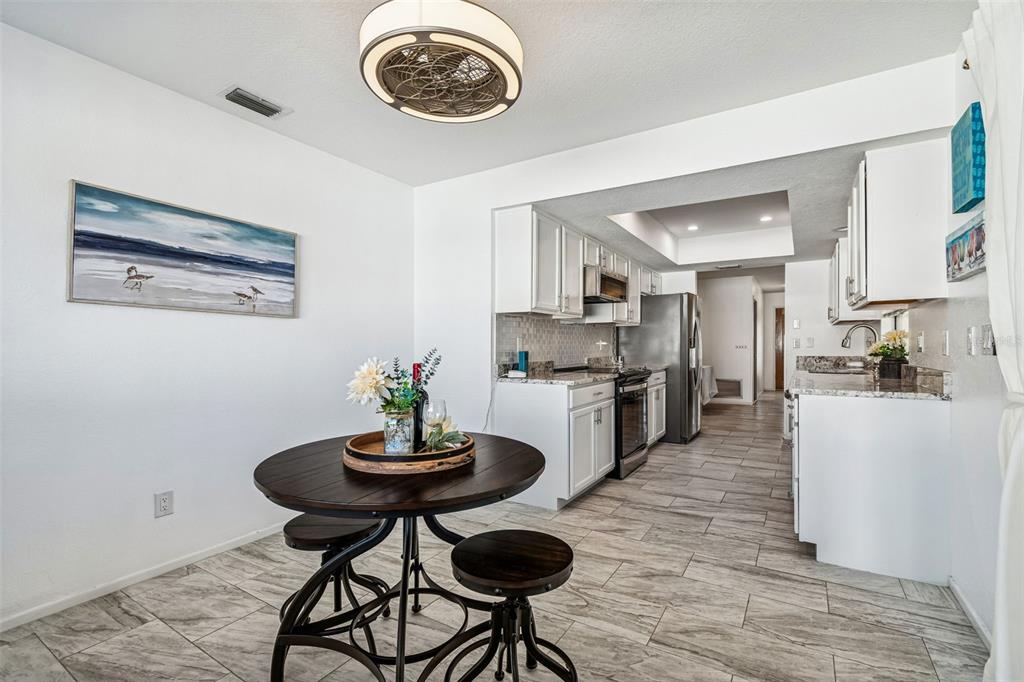 14301 86th Avenue North Seminole, FL 33776 - Photo 35 of 59 a view of a dining room with furniture a chandelier and wooden floor