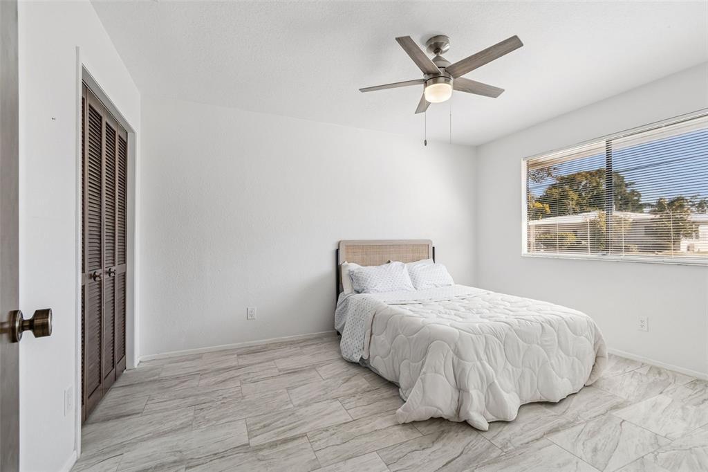 14301 86th Avenue North Seminole, FL 33776 - Photo 38 of 59 a bedroom with a bed and window