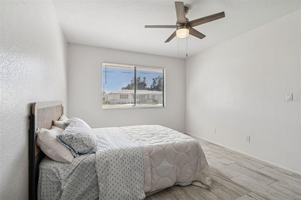 14301 86th Avenue North Seminole, FL 33776 - Photo 39 of 59 a bedroom with a bed and a painting on the wall