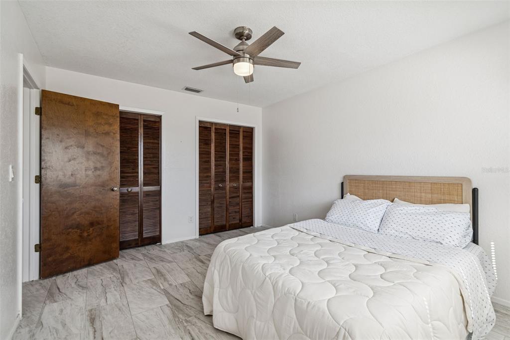 14301 86th Avenue North Seminole, FL 33776 - Photo 40 of 59 a bedroom with a large bed and a large window