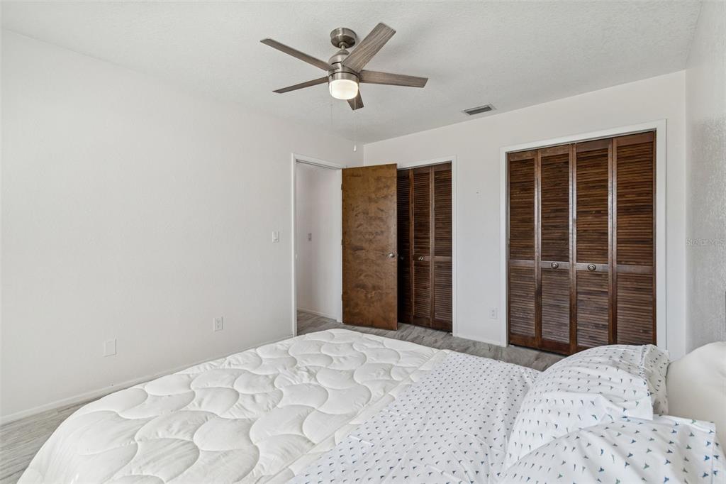 14301 86th Avenue North Seminole, FL 33776 - Photo 41 of 59 a bedroom with a bed and a large window