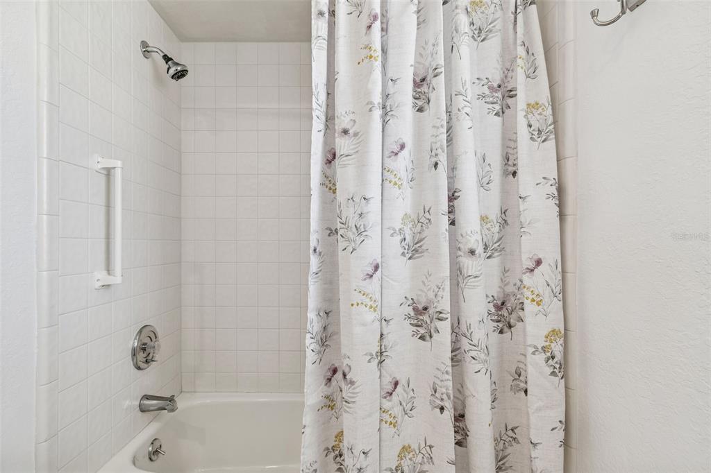 14301 86th Avenue North Seminole, FL 33776 - Photo 46 of 59 a bathroom with a shower curtain