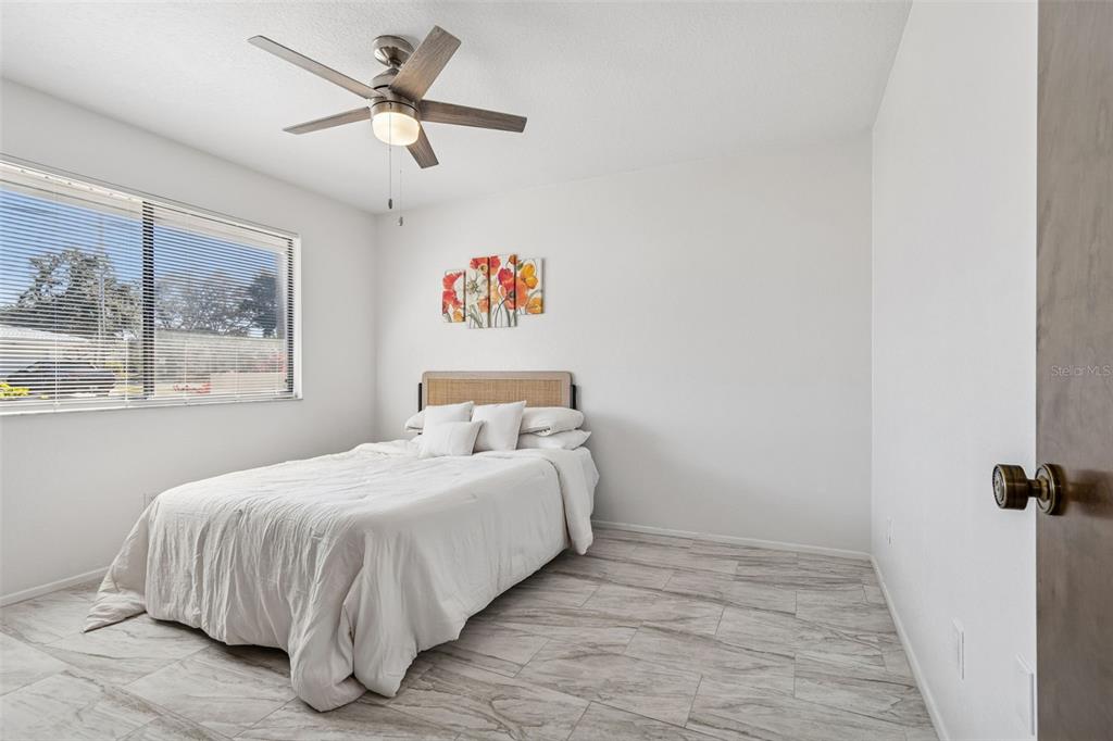 14301 86th Avenue North Seminole, FL 33776 - Photo 47 of 59 a bedroom with a bed and a painting on the wall