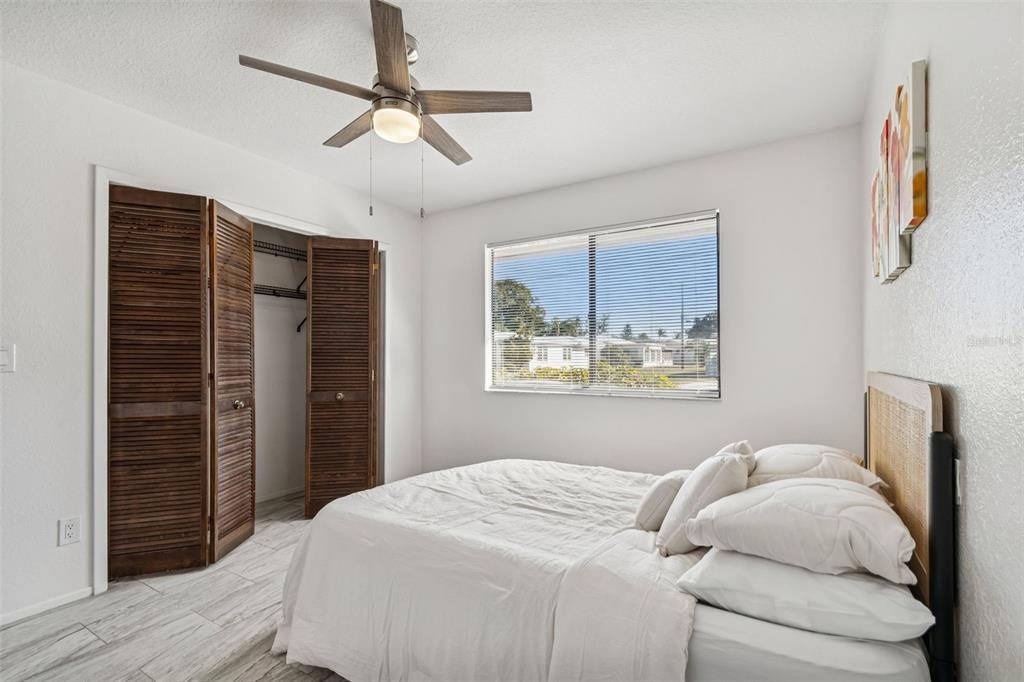 14301 86th Avenue North Seminole, FL 33776 - Photo 48 of 59 a bedroom with a bed and a window