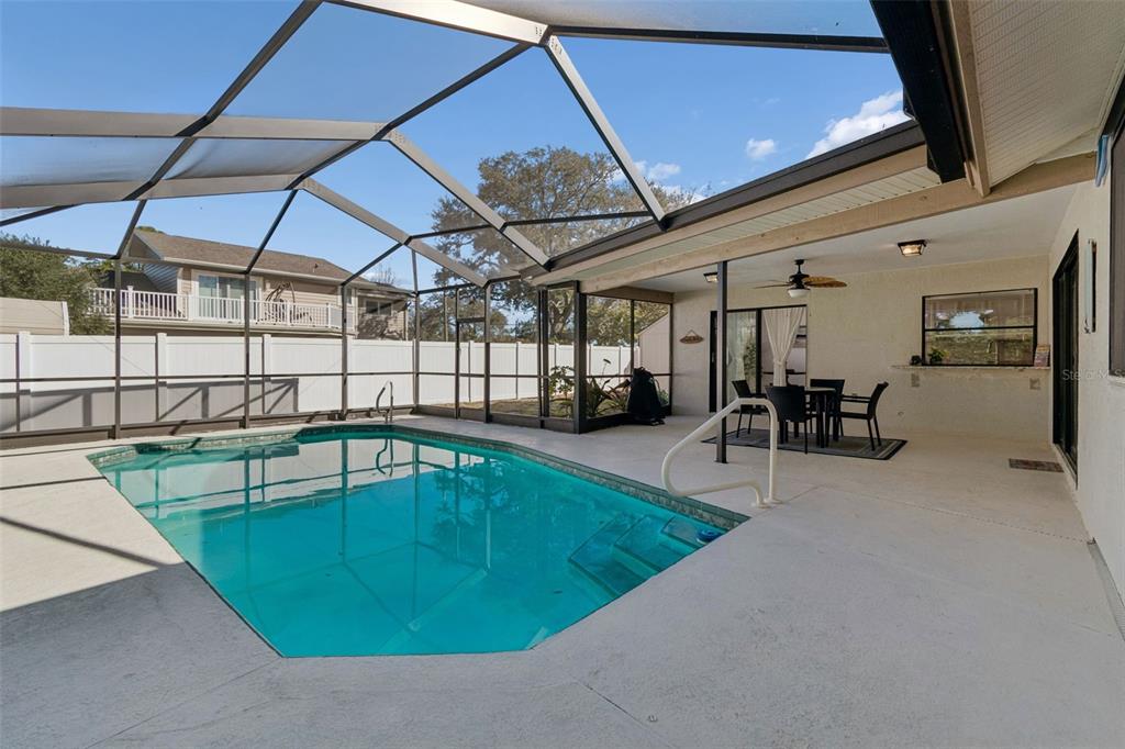 14301 86th Avenue North Seminole, FL 33776 - Photo 58 of 59 a view of a swimming pool with a patio
