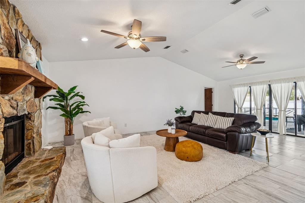 14301 86th Avenue North Seminole, FL 33776 - Photo 6 of 59 a living room with furniture flowerpot and a fireplace