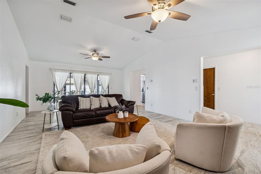 14301 86th Avenue North Seminole, FL 33776 - Photo 8 of 59 a living room with furniture and a large window
