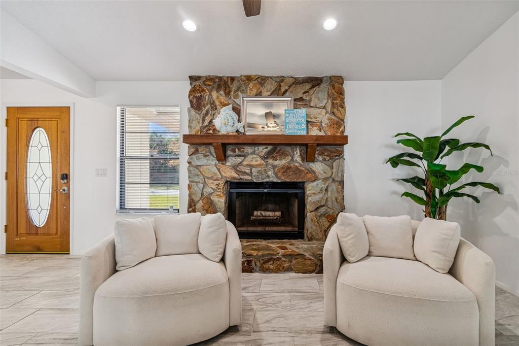14301 86th Avenue North Seminole, FL 33776 - Photo 9 of 59 a living room with furniture and a fireplace