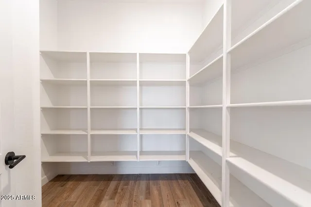 a view of walk in closet with empty racks