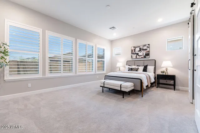 a spacious bedroom with a bed and a window