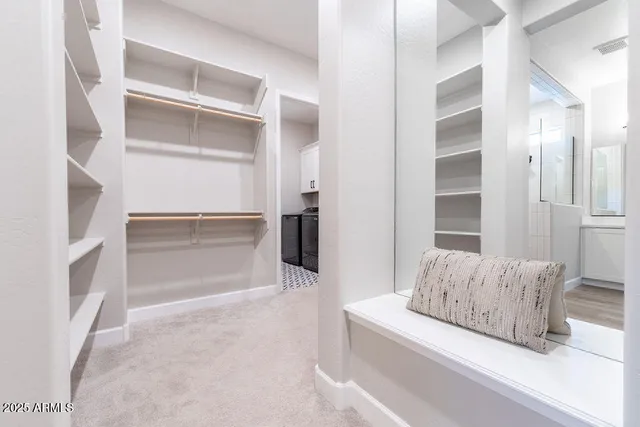 a living room with a couch and a potted plant on a dresser