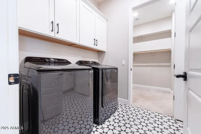 a kitchen with white cabinets and white appliances