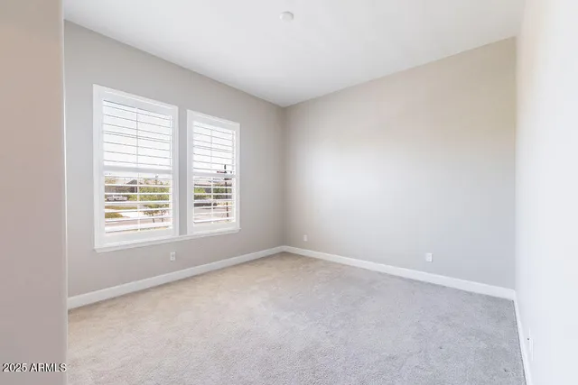an empty room with windows and closet
