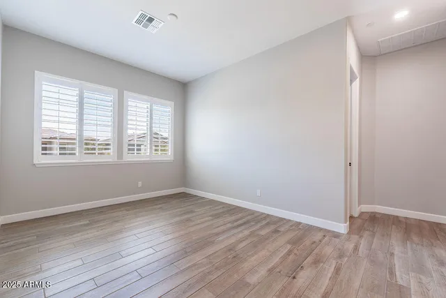 an empty room with closet and a bathroom