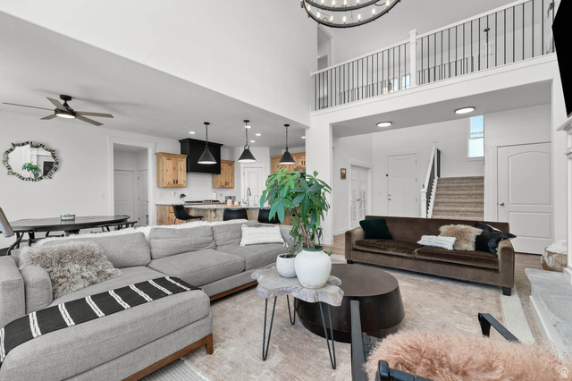 500 North 516th Street West, Unit 19 Mapleton, UT 84664 - Photo 4 of 41 High ceilings with an upper-level balcony featuring metal railings, a stone fireplace, wood-finish flooring, and recessed lighting