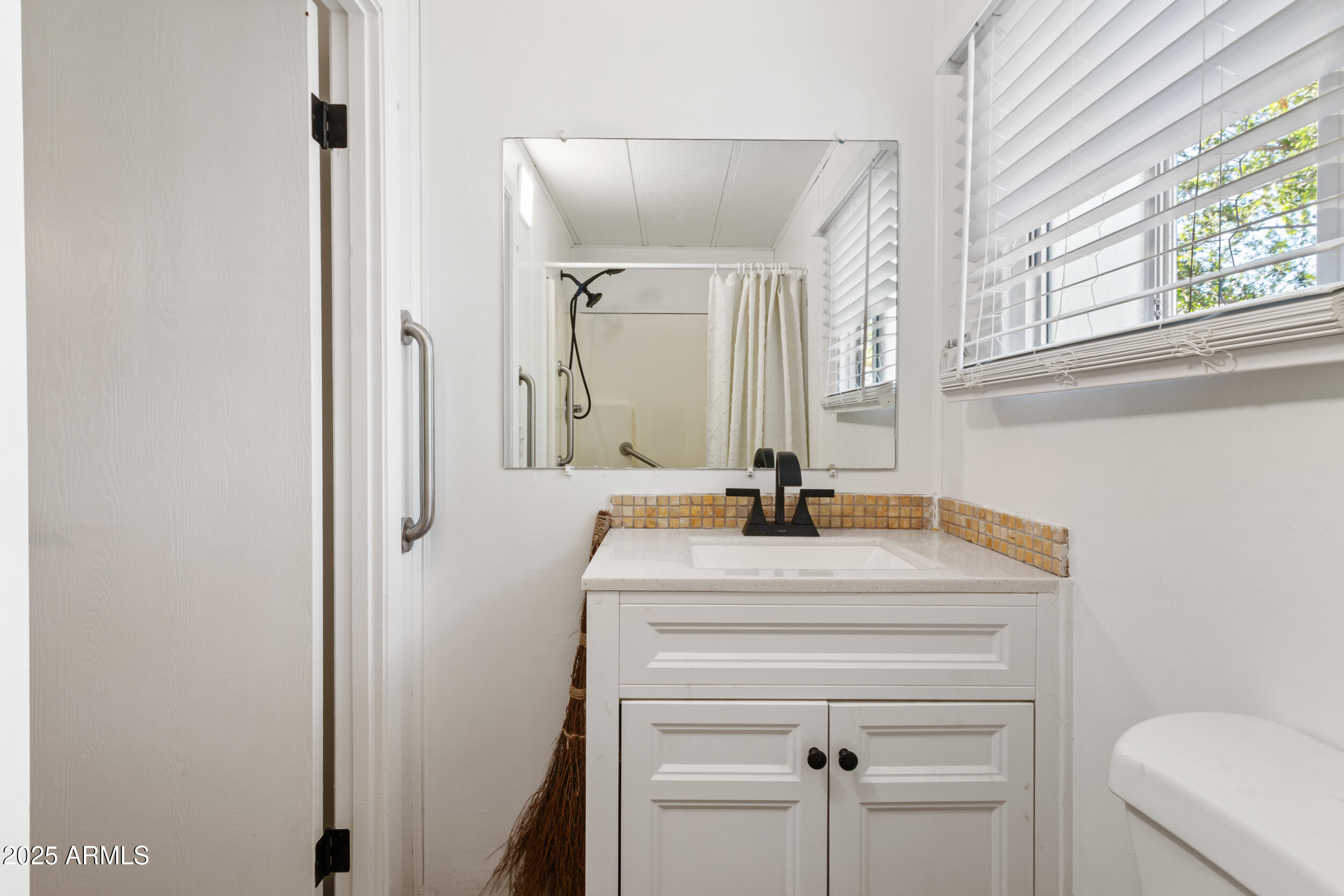 701 South Dobson Road, Unit 357 Mesa, AZ 85202 - Photo 13 of 66 a bathroom with a sink and a mirror