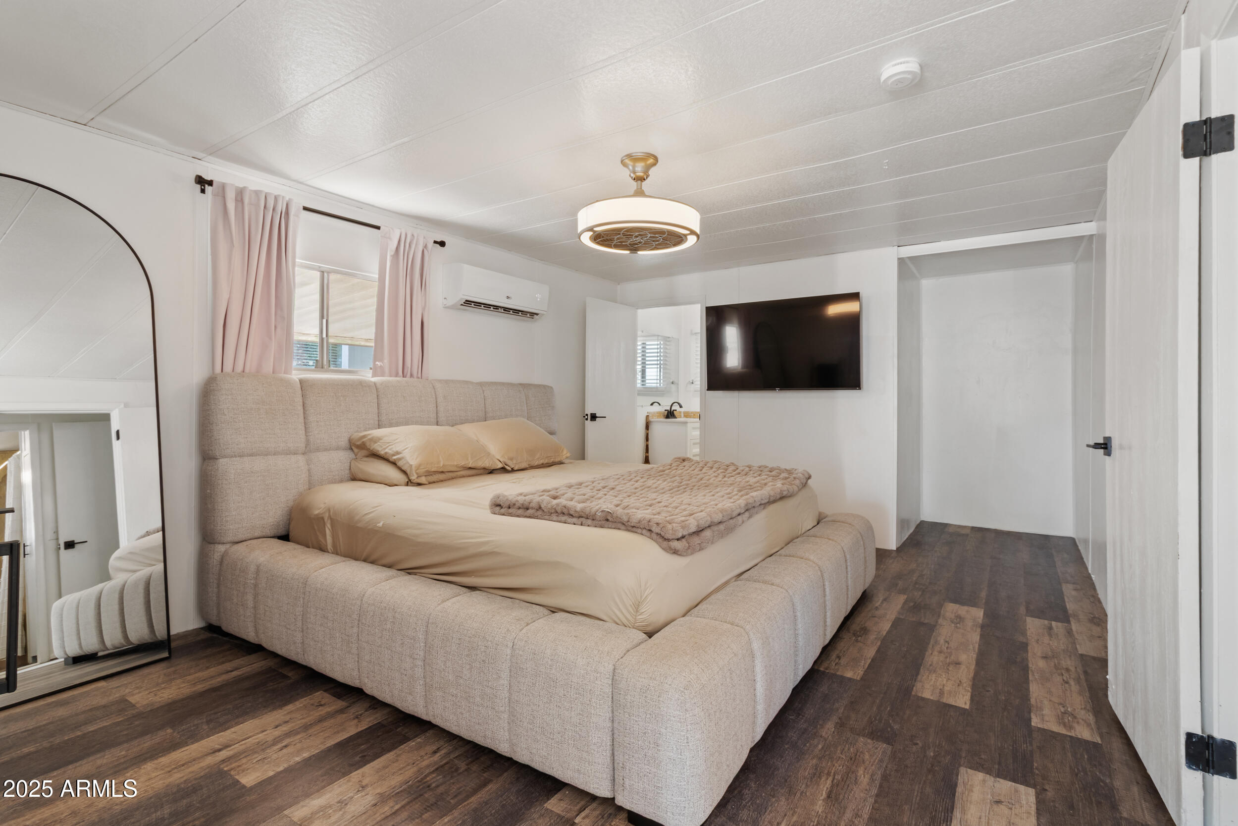 701 South Dobson Road, Unit 357 Mesa, AZ 85202 - Photo 14 of 66 a spacious bedroom with a bed and a flat screen tv