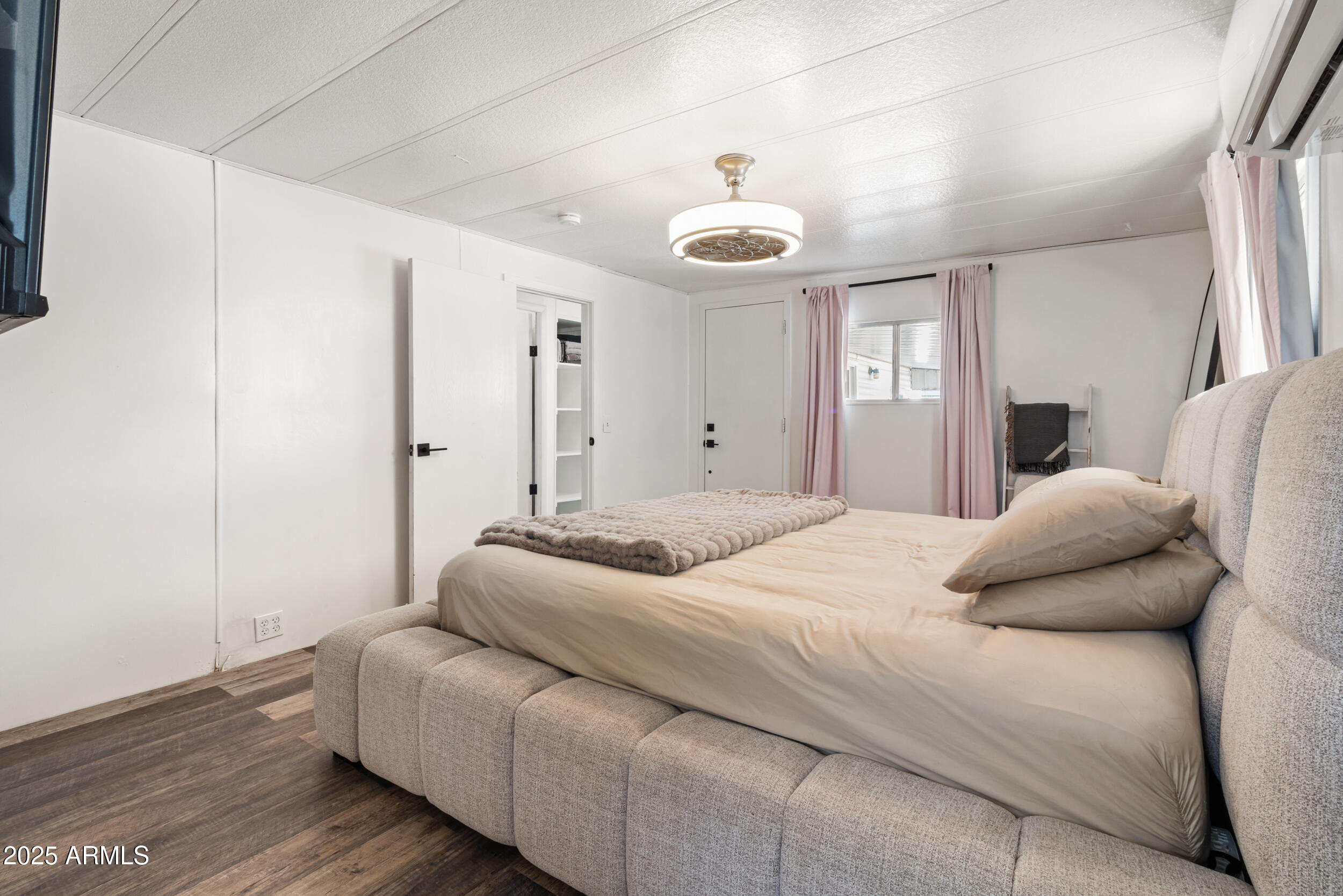 701 South Dobson Road, Unit 357 Mesa, AZ 85202 - Photo 15 of 66 a bedroom with a bed and wooden floor