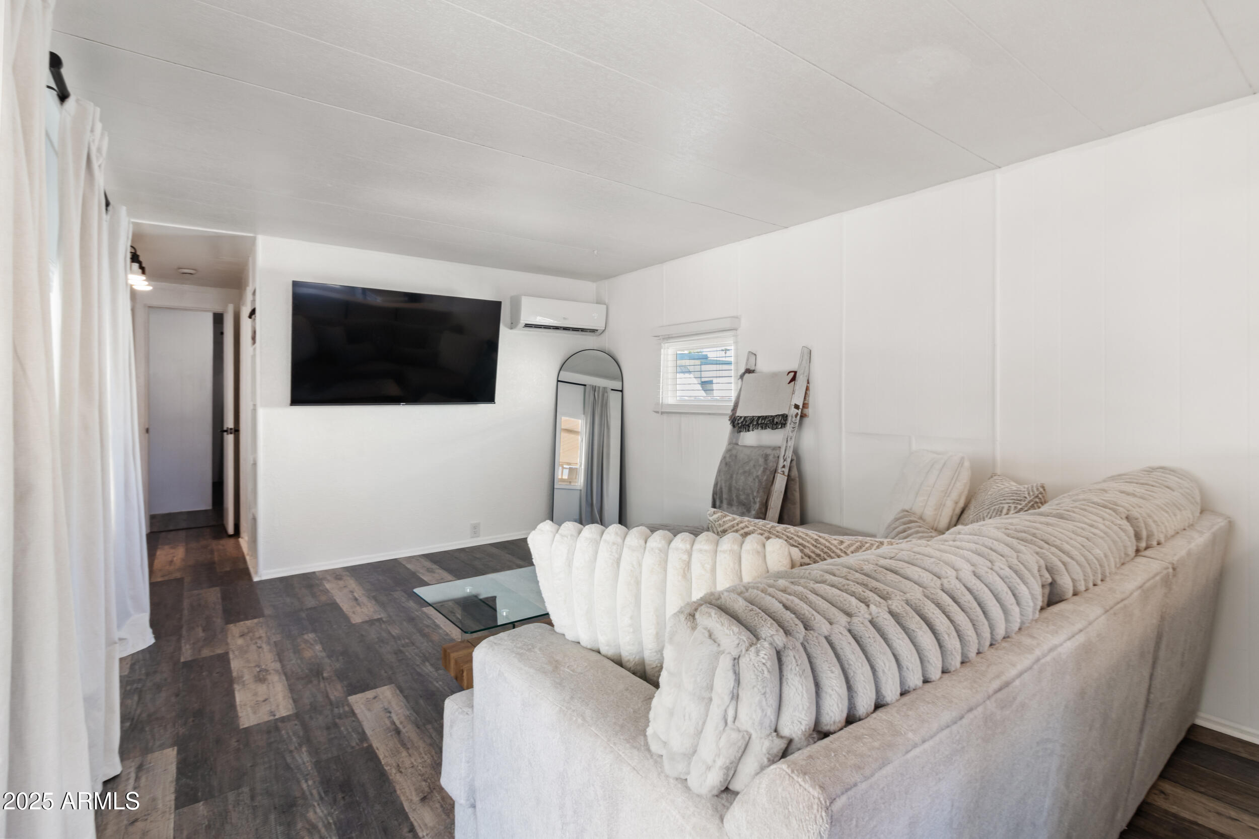 701 South Dobson Road, Unit 357 Mesa, AZ 85202 - Photo 2 of 66 a living room with a couch and a flat screen tv