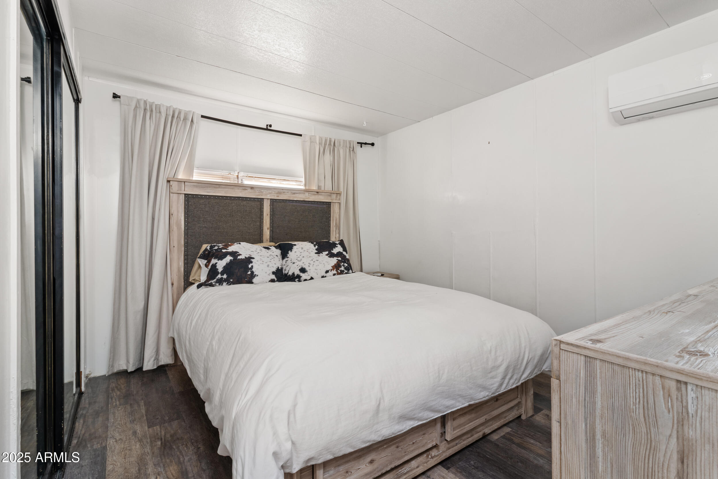 701 South Dobson Road, Unit 357 Mesa, AZ 85202 - Photo 21 of 66 a bedroom with a bed and wooden floor