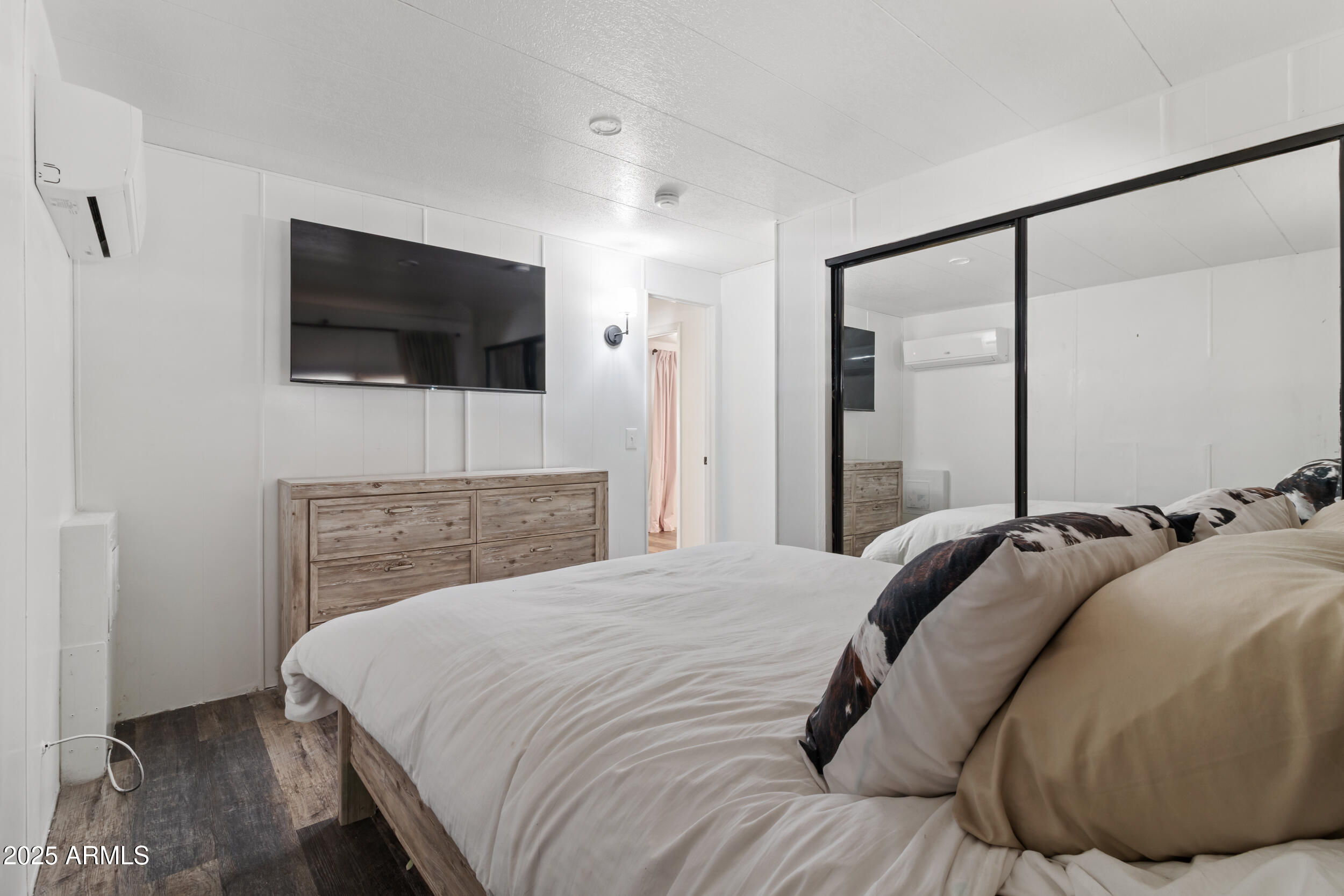 701 South Dobson Road, Unit 357 Mesa, AZ 85202 - Photo 23 of 66 a bedroom with a bed and a flat screen tv