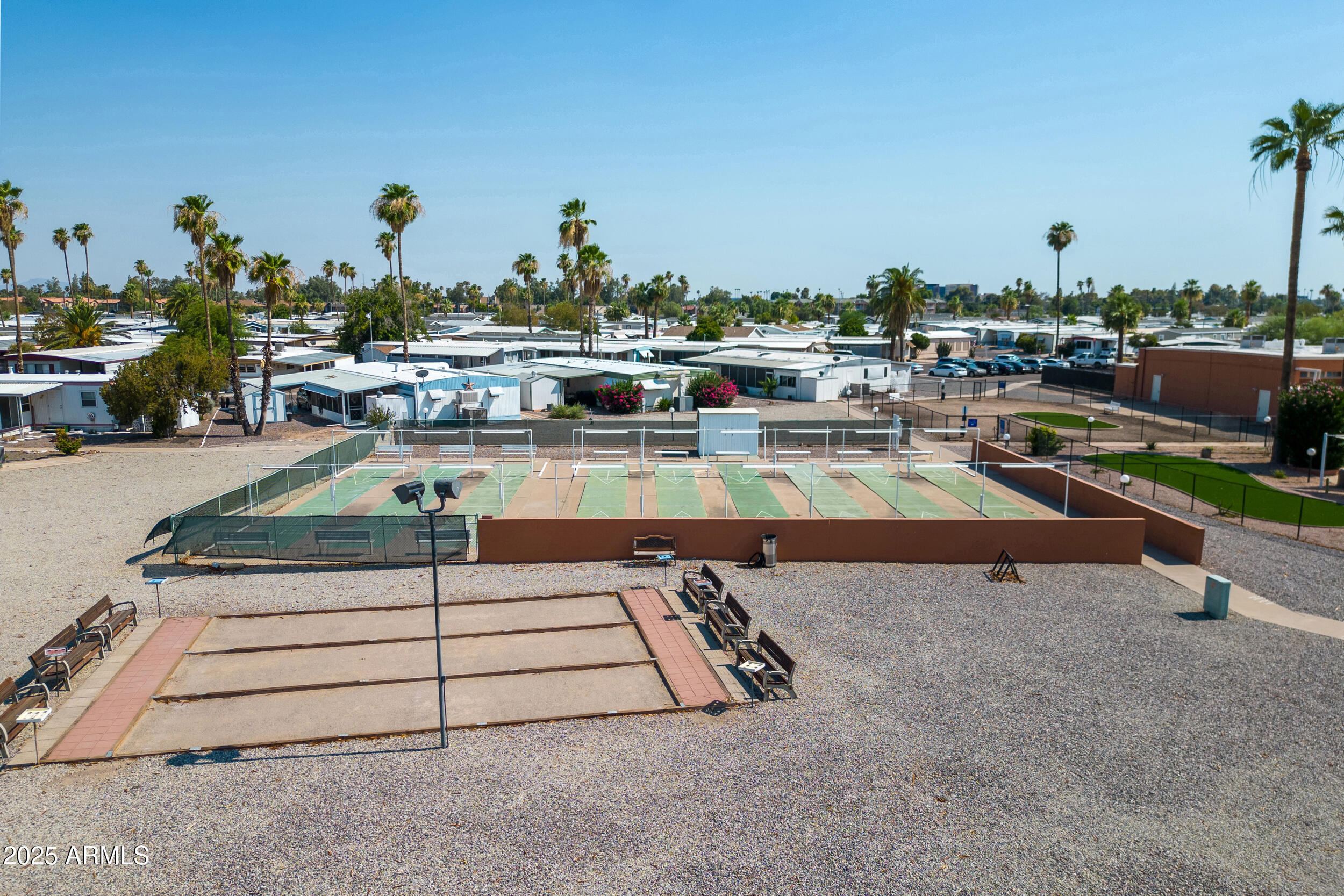 701 South Dobson Road, Unit 357 Mesa, AZ 85202 - Photo 42 of 66 a view of a swimming pool with outdoor seating and buildings in the background