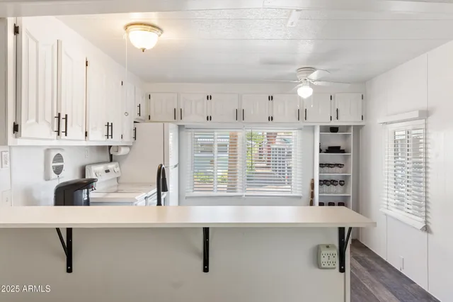 a kitchen with a sink cabinets and window
