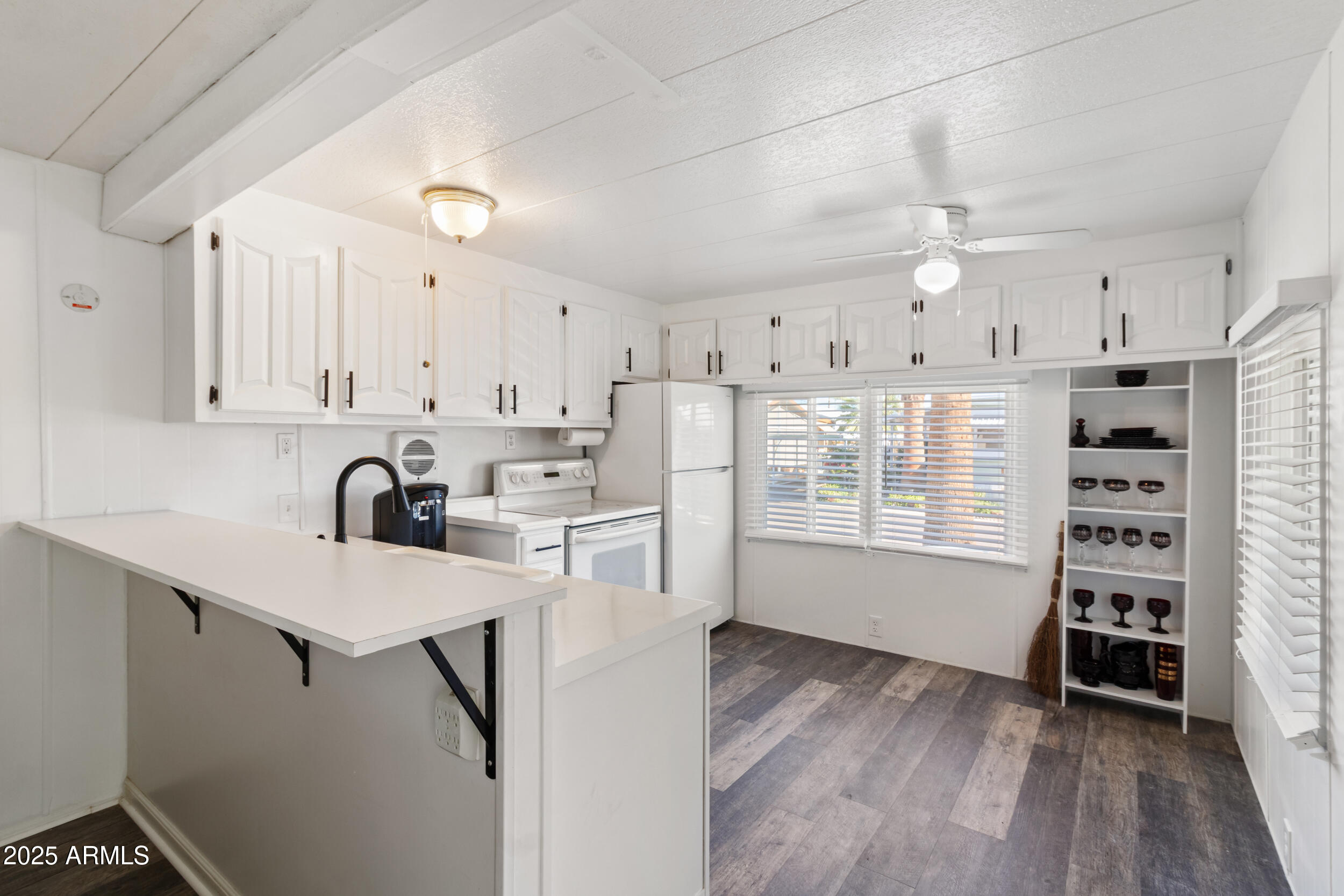 701 South Dobson Road, Unit 357 Mesa, AZ 85202 - Photo 7 of 66 a kitchen with granite countertop a sink cabinets and wooden floor