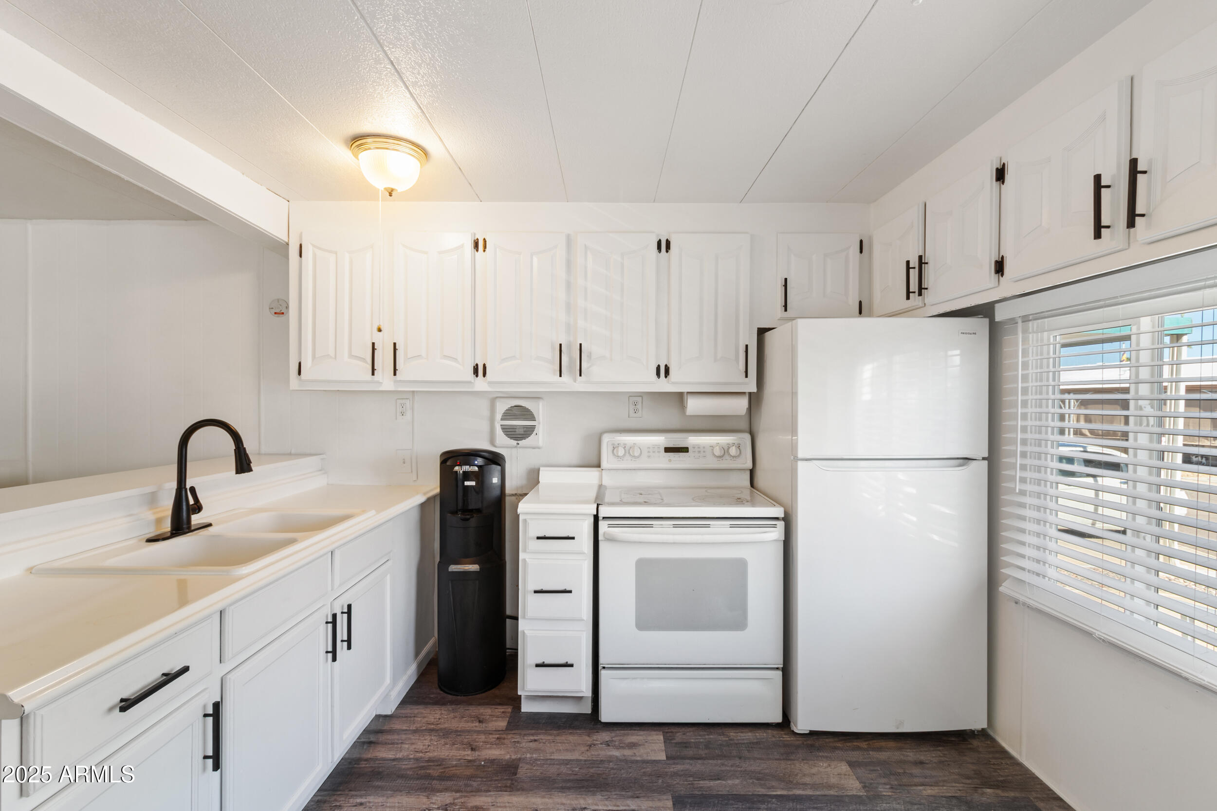 701 South Dobson Road, Unit 357 Mesa, AZ 85202 - Photo 8 of 66 a kitchen with white cabinets and white appliances