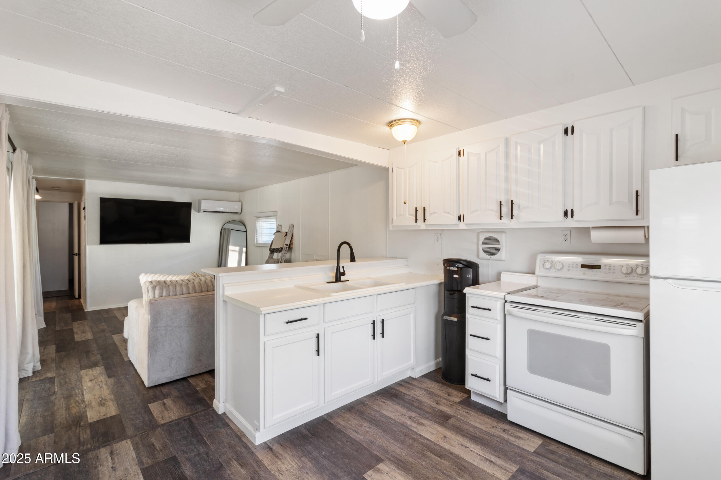 701 South Dobson Road, Unit 357 Mesa, AZ 85202 - Photo 9 of 66 a kitchen with a stove and white cabinets