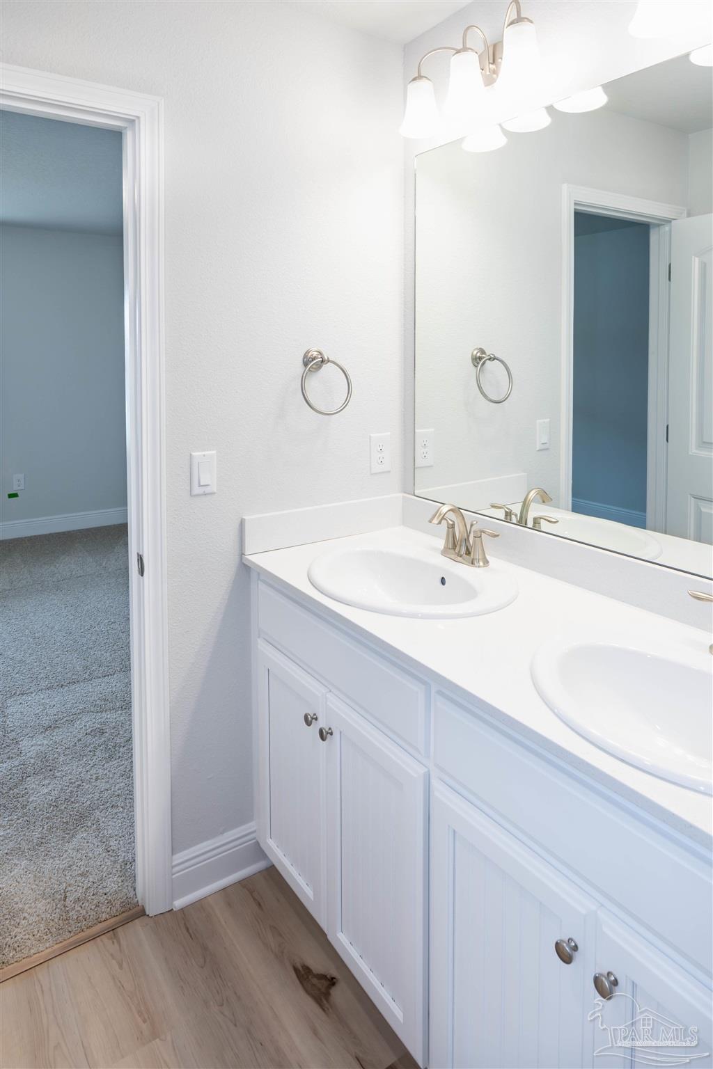 6288 Pineapple Drive Milton, FL 32570 - Photo 11 of 32 a bathroom with a sink and a mirror