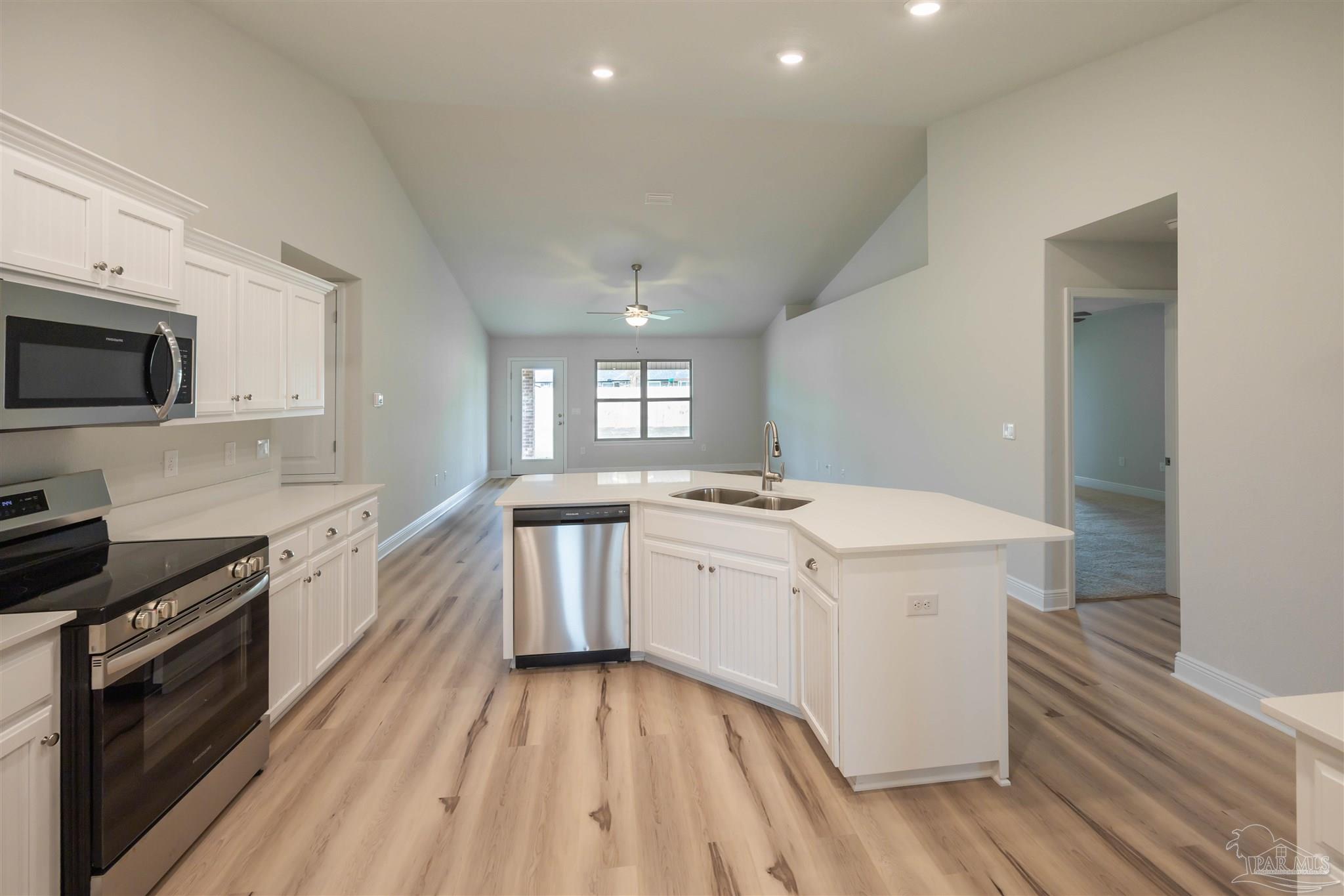 6288 Pineapple Drive Milton, FL 32570 - Photo 18 of 32 a kitchen with a sink stove and microwave