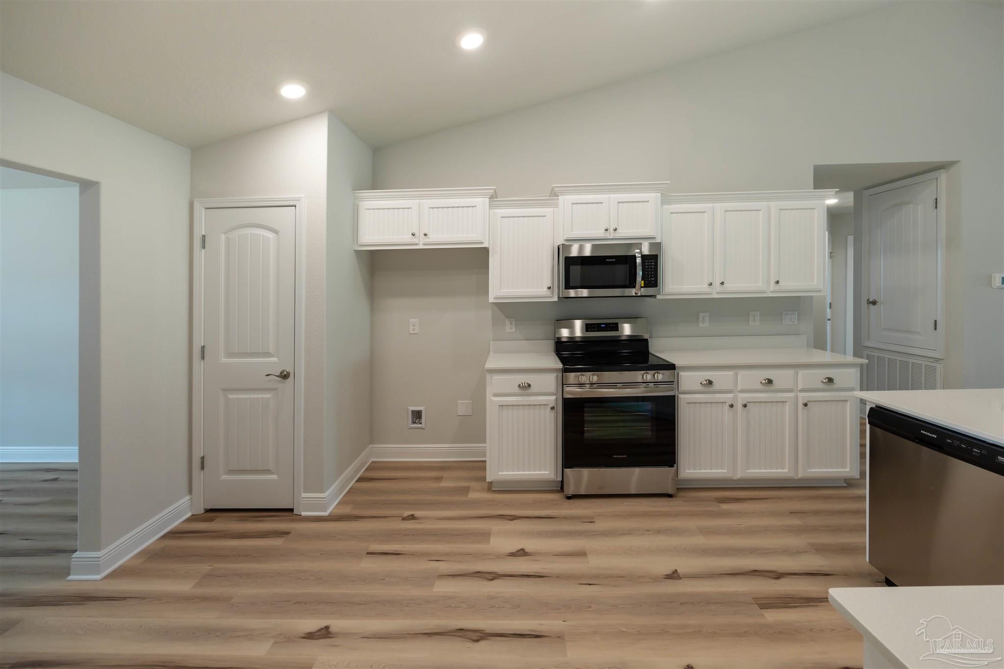 6288 Pineapple Drive Milton, FL 32570 - Photo 19 of 32 a kitchen with granite countertop a stove and a refrigerator